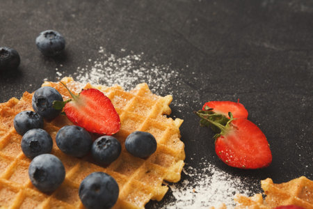 Creating a Colorful Collage of Waffles With Fresh Berries on a Dark Surface for Dessert Ideas