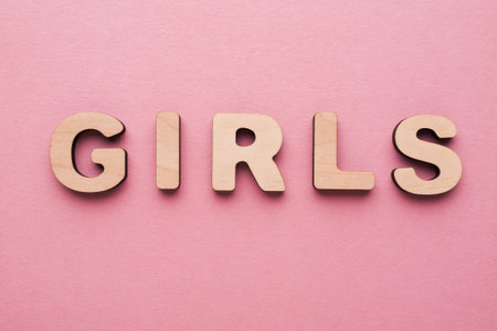 Wooden Letters Spell Girls on a Pink Background for Creative Activities and Education