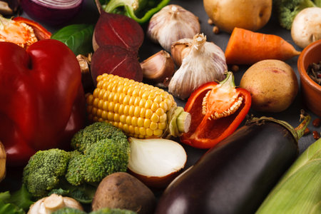 Collection of Fresh Vegetables Arranged in a Colorful Mosaic on a Dark Surface