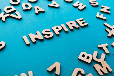 Letters on a Blue Background Create a Focus on the Word Inspire Among Scattered Alphabet Pieces