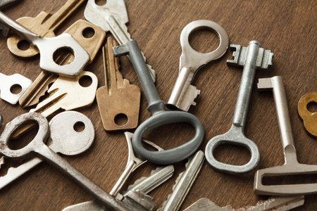 Key Collage That Shows Various Types of Keys on a Wooden Surface in a Collection of Shapes and Sizes