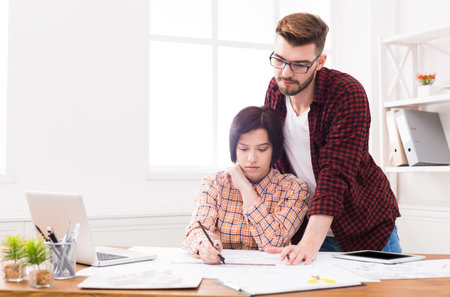 Young Adults Collaborate on Project in Office Space During Daytime Hours