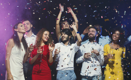 Group of Friends Celebrating With Drinks During a Festive Party at Night