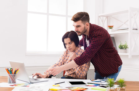 Team Working on a Project at a Desk in a Bright Office Space During the Afternoonの写真素材