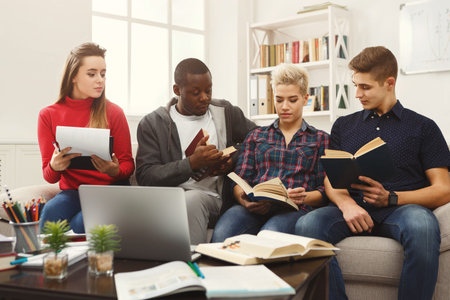Students Engage in Group Study Session at a Cozy Location With Books and a Laptop on Table
