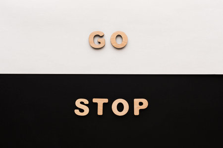 Wooden Letters on Contrasting Backgrounds Show Different Commands to Follow or Ignoreの写真素材