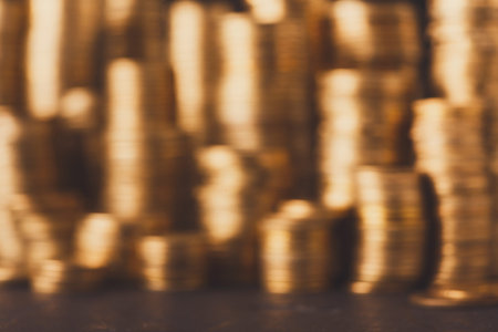 Collection of Coins in a Blurred Setting Showing a Stack of Gold Coins in a Unique Arrangementの写真素材