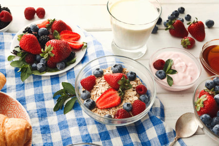 Collection of Breakfast Items on a Table With Fruits, Yogurt, and Oatmeal Bowl