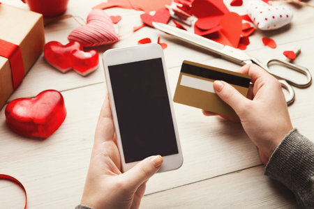 Collection of Tools for Shopping and Crafting on Valentines Day With a Phone and Cardの写真素材