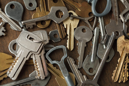Collection of Metal Keys Arranged in a Random Pattern on a Wooden Surface for a Set Design