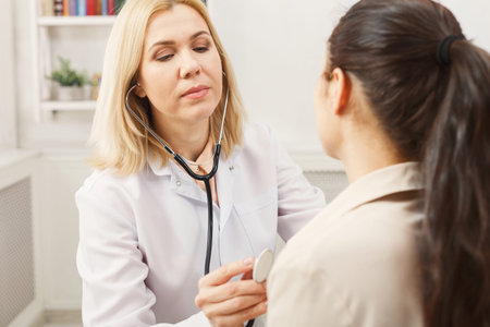 Doctor Listens to Patient Heart During a Medical Checkup Inside a Clinic Room