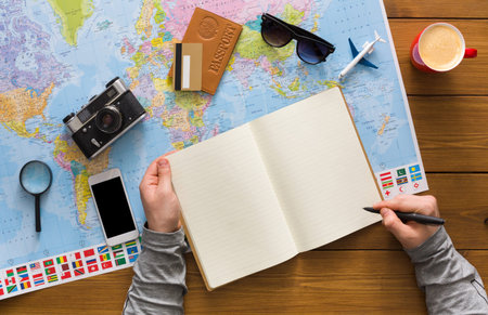 Planning a Trip With a Map, Notebook, and Travel Items on a Wooden Table