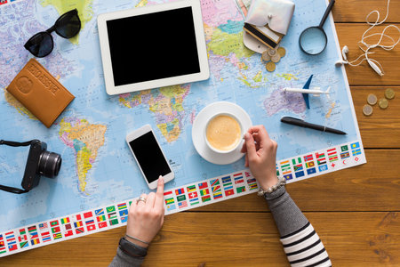 Planning a Trip With Technology and a Cup of Coffee at a Home Workspace