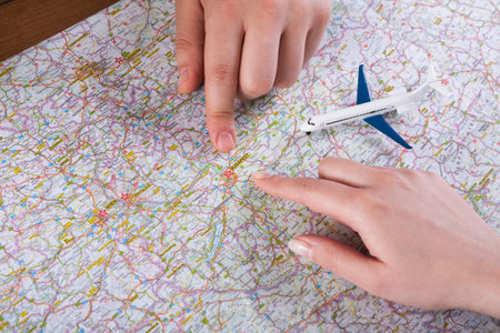 Planning a Trip With a Map and Model Airplane on a Table in a Bright Room