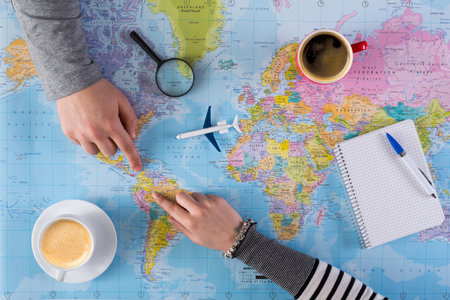 Planning a Travel Journey With Coffee and a World Map in the Afternoon