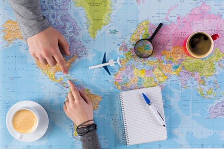 Planning a Trip While Looking at a World Map and Sipping Coffee in the Afternoon