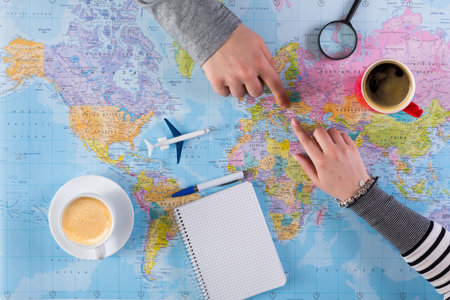 Planning a Trip With Maps, Coffee, and Notes on a Table