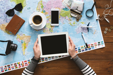 Woman planning her trip and choosing travel agency in tablet