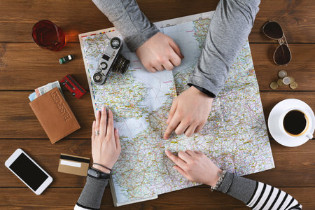 Young couple exploring map to find the best country where to go together