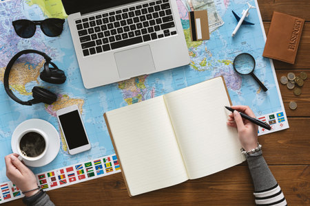Woman drinking coffee and planning her trip in the office