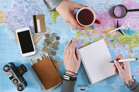 Planning trip together with cup of tea and notes