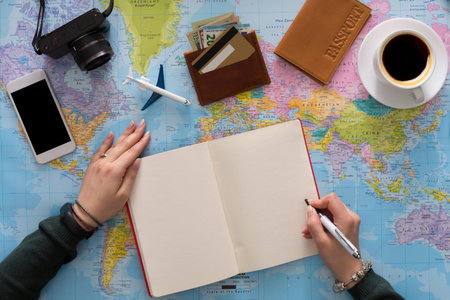 Planning a Travel Adventure With a Map, Passport, and Notes at a Table