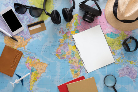 Planning a Travel Adventure With Essentials on a World Map in a Flat Lay Setup