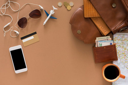 Items for Travel Preparation on a Flat Surface With a Coffee Cup and a Map