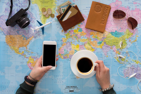 Planning a Trip With Travel Essentials and a Map on a Table at Home