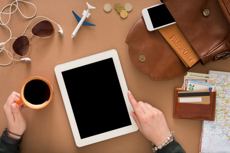 Travel Planning With Devices on Workspace at Home in the Afternoon