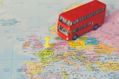 Red Bus Model on a Map Highlighting France Among Other European Countriesの写真素材