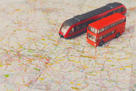 Model Train and Bus on a Map Showing Roads and Cities in Germany