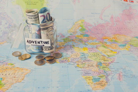 Saving Money for Adventure Travel Around the World With a Map and Coins
