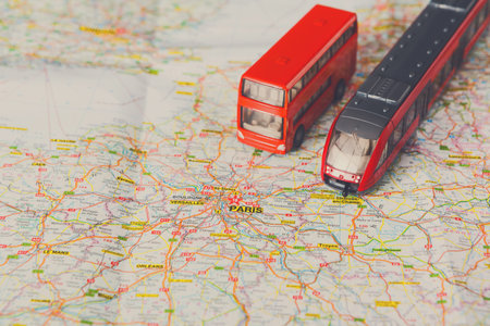 Model Bus and Train on a Map of Paris With Routes and City Details Visible