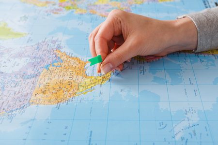 Person Places Marker on a Map of Mexico During Travel Planning at Homeの写真素材