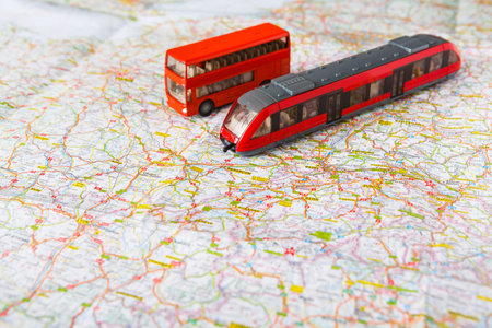 Model Bus and Train on Map During Day Showing Transportation Planning and Travel Options