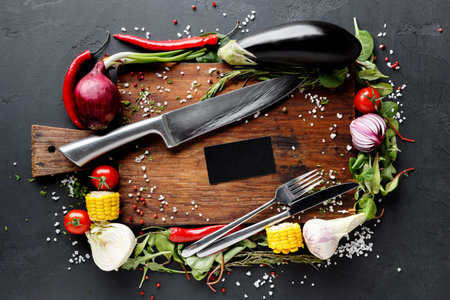 Fresh Vegetables and Kitchen Tools Arranged on a Cutting Board With Spices and Herbs