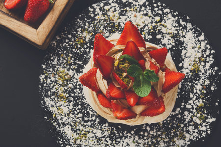 Delicious Dessert Topped With Strawberries and Nuts Served in a Cafe During Afternoonの写真素材