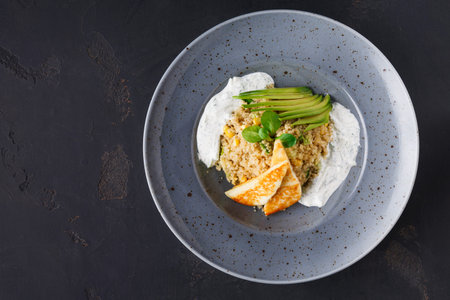 Dish With Grain, Yogurt, and Vegetables on Gray Plateの写真素材