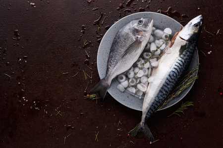 Fresh Fish on a Plate With Ice and Herbs Prepared for Cooking in a Kitchen Settingの写真素材