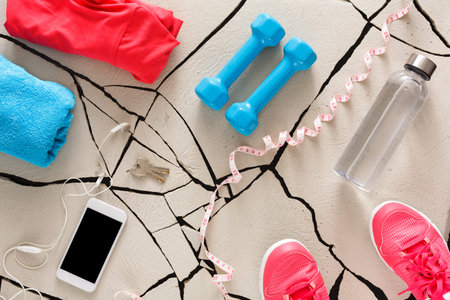 Bright Workout Gear and Equipment on a Floor With Cracks Ready for Exercise Session