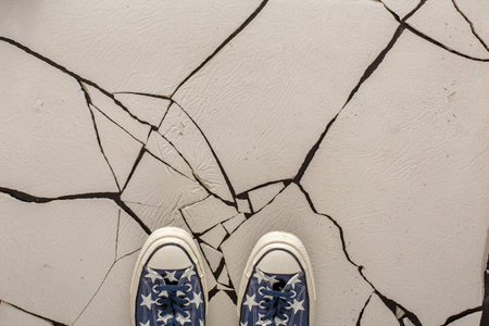 Colorful Shoes on Cracked White Surface in Indoor Space During Daytime