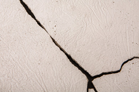 Surface With a Visible Crack and Textured Pattern During Daylight Hours