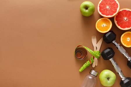 Healthy Lifestyle Setup With Fruits, Exercise Equipment, and Measurement Tools in a Simple Layoutの写真素材