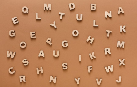 Wooden Letters Scattered on a Brown Surface During a Creative Activity for Children