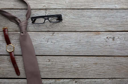 Accessories Laid out on a Wooden Table Ready for a Professional Appearance or Meetingの写真素材