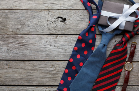 Collection of Ties and a Gift Box on a Wooden Surface for a Special Occasion