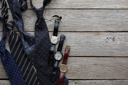 Collection of Ties and Watches on Wooden Surface in a Casual Setting