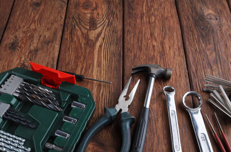Tools and Equipment Arranged on Wooden Surface for DIY Projects and Repairs in Home Workshop