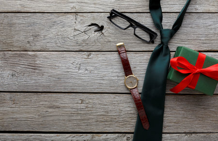 Collection of Items for a Special Occasion With a Watch, Tie, Glasses, and a Gift Boxの写真素材